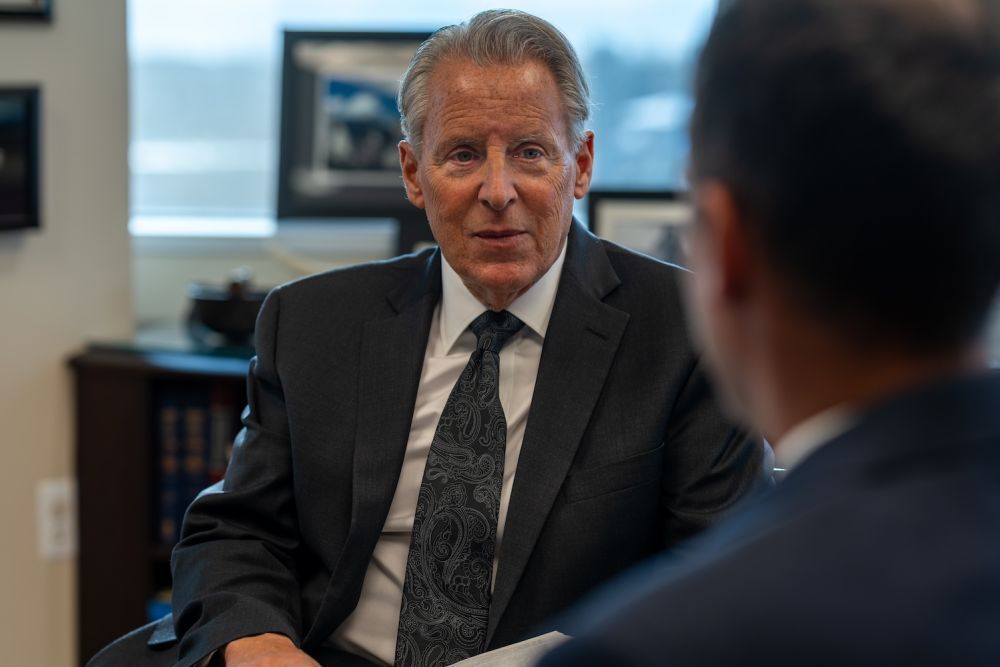An attorney meets a prospective client across a desk in a North Shore law office